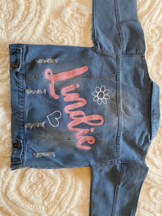 Denim jacket with Lindie in pink chainstitch, a daisy and a heart