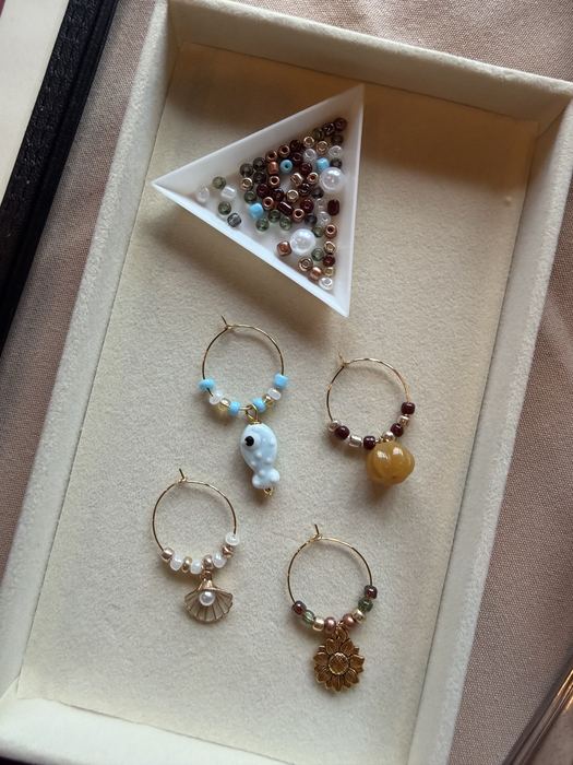 Wine glass charms with evil eye and heart charms