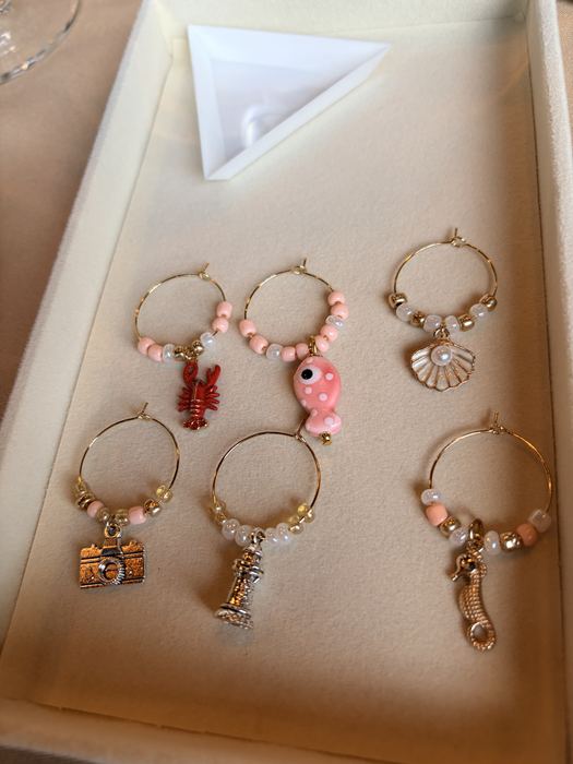 Pink and wine glass charms in a tray